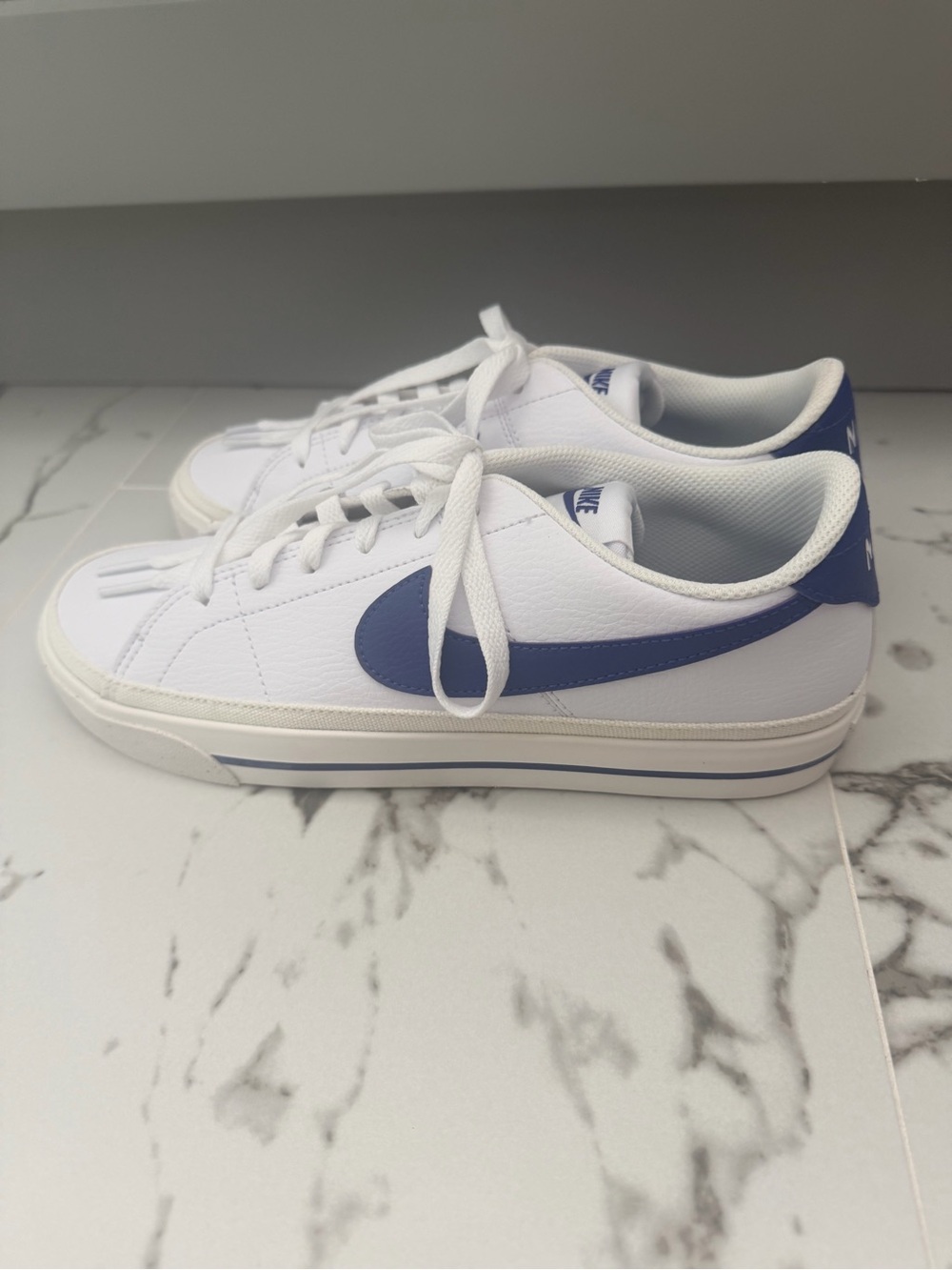 Nike White Low-Top Sneakers with Blue Swoosh